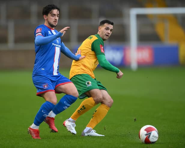 CARLISLE, ENGLAND - NOVEMBER 06: Carlisle player Zach Clough (l) challenges Horsham player Tom Kavanagh during the  Emirates FA Cup First Round match between Carlisle United and Horsham at Brunton Park on November 06, 2021 in Carlisle, England. (Photo by Stu Forster/Getty Images)