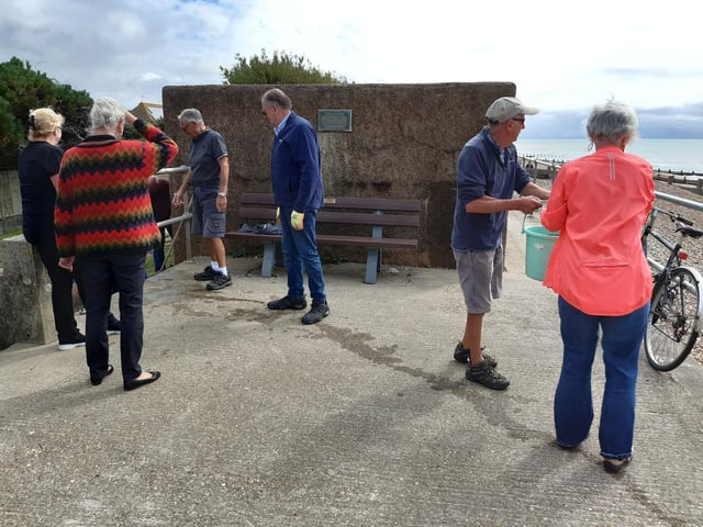 A bucket chain of volunteers from Ferring History Group and Ferring Conservation Group, including Worthing West MP Sir Peter Bottomley, form a bucket chain to bail out nine inches of water from the Ferring pillbox