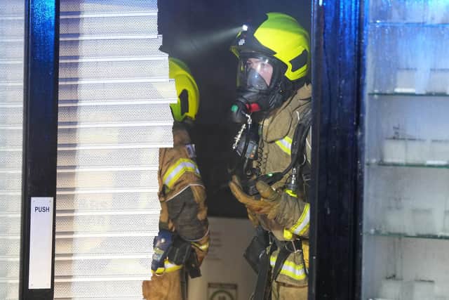 Firefighters at the scene of a blaze in a mobile phone repair shop in West Street, Horsham