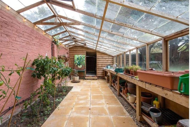 In the corner of the garden is a glass house and adjoining studio with power and water connected