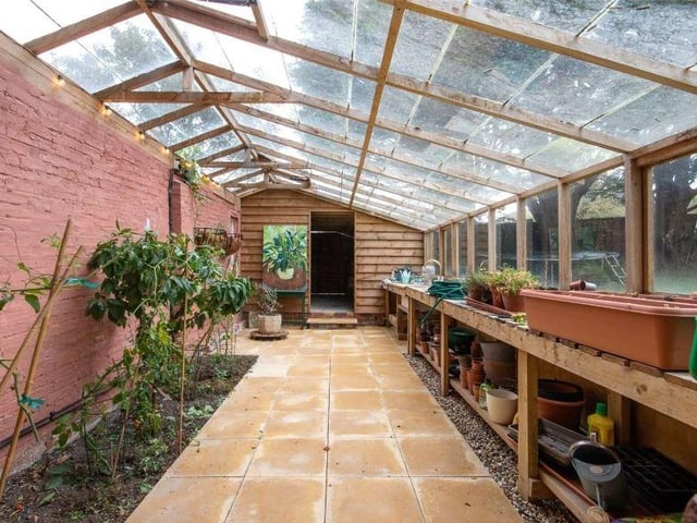 In the corner of the garden is a glass house and adjoining studio with power and water connected