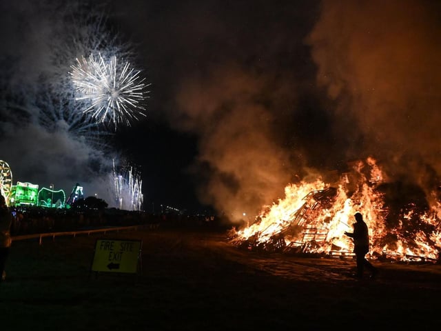 Saturday's bonfire and fireworks, with the funfair in the background