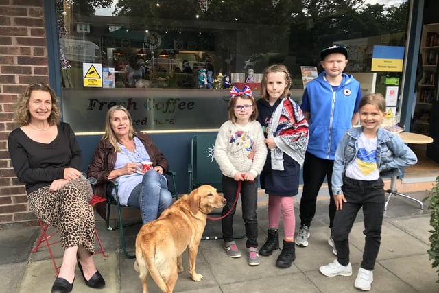 Patricia Foong, with friend Sue and Gaby the dog, with Elizabeth Blatherwick (7) Hattie Blatherwick (10) and Ukrainian visitors to the Hub Tim (11) and Daria (7) 
On the green outside the Hub.