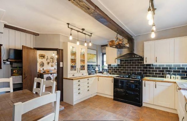 An attractive kitchen/breakfast room has two walk in pantries and leads into the dining room