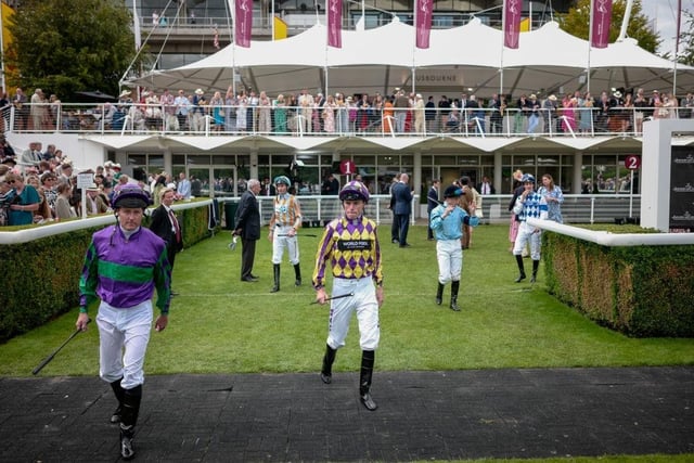 CHICHESTER, ENGLAND - AUGUST 03: Jockeys enter the parade ring at Goodwood Racecourse on August 03, 2023 in Chichester, England. (Photo by Alan Crowhurst/Getty Images):More images from Ladies' Day, 2023, at Glorious Goodwood