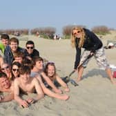 A mad March day as Chichester University students dig themselves a hole at the beach