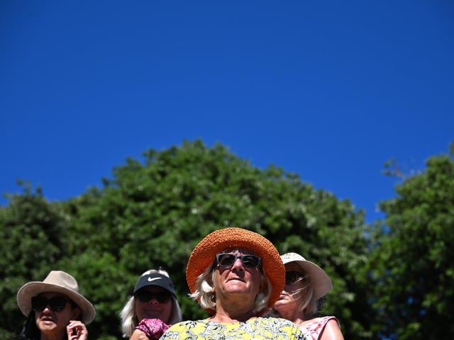 Fans wearing hats watch on during Day Three of the Rothesay International Eastbourne at Devonshire Park