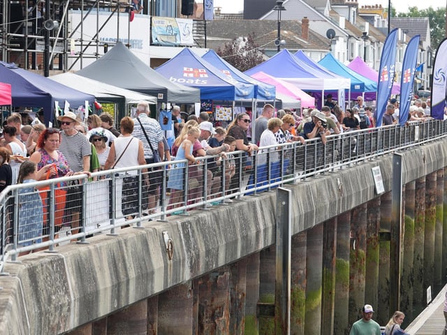 Crowds watch on from the riverside