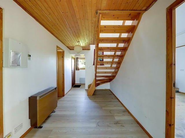The reception hall with open staircase to the first floor