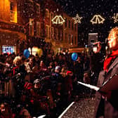 Seamus Cullen singing to the crowds as snow fell from the rooftops after the switch on of Christmas lights