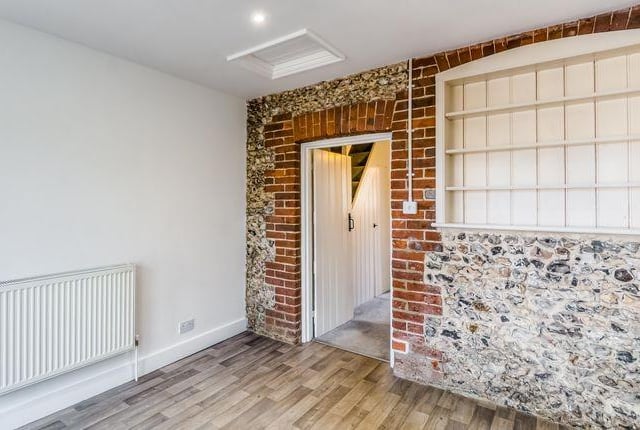 The interior has attractive exposed original flint wall.