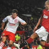 Matt Tubbs in action at Old Trafford, under pressure from Wes Brown | Picture: Jon Rigby
