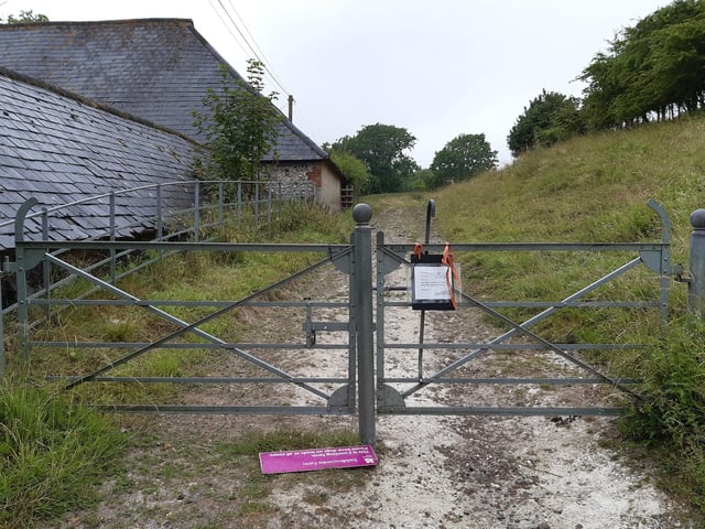 Go through this gate alongside the buildings
