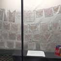 Some 36 handkerchiefs are displayed in a window opposite Fork restaurant in Station Street, Lewes, with notes and advice from older people