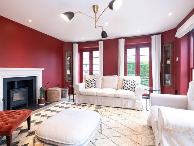 The sitting room has a Chesney wood burner and full height fitted, bespoke bookshelves