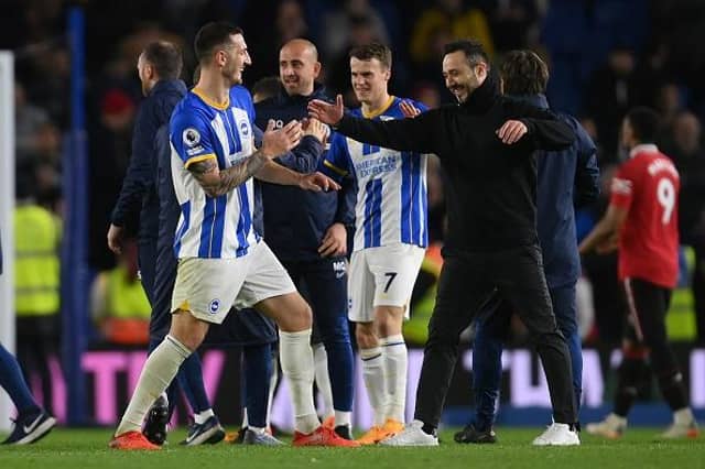 Brighton and Hove Albion head coach Roberto De Zerbi and skipper Lewis Dunk share a moment