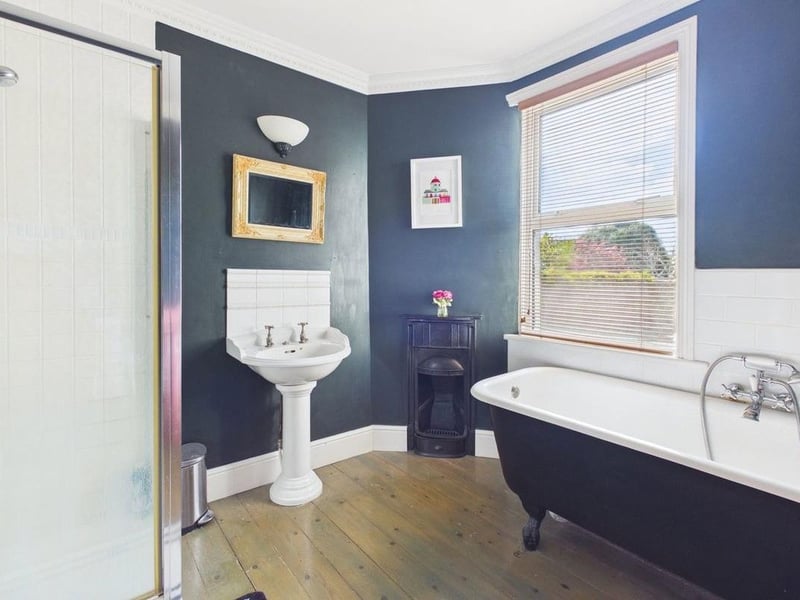 The family bathroom is fitted with a roll-top clawfoot bath and separate shower