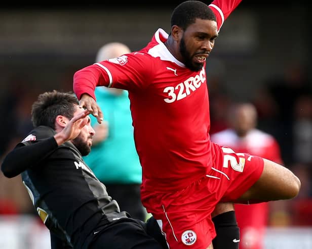 Michael Smith of Peterborough tackles Gavin Tomlin of Crawley in a League One match in 2014 - the Posh are back on the Reds' list of league opponents next season | Photo by Jordan Mansfield/Getty Images