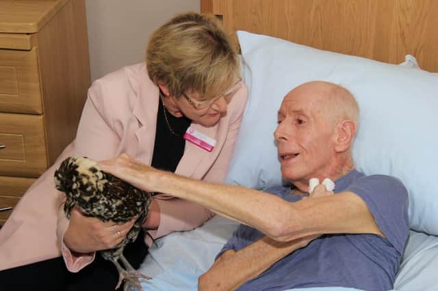 Abi Smith, Deputy Manager, takes Bridget to visit resident John Read in his room