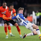 Evan Ferguson of Brighton & Hove Albion is challenged by Gabriel Osho of Luton Town during the Premier League match