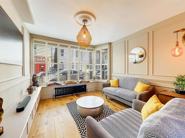 The living room features a built-in media unit