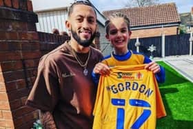 Former Stags player Kellan Gordon presents the signed shirt to fan Brendan Cliff at the seven-year-old's home in Clipstone.