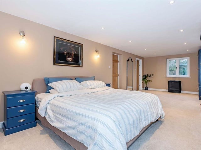 The master bedroom suite boasts a triple-aspect design, with a stylish en-suite shower room