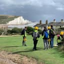 Yr 13 A-level geology students and Curriculum Support Officer for Geology Penny Fenton at the iconic ‘Fishermen’s Cottages and Seven Sisters’ view near Cuckmere Haven
