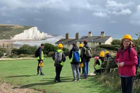 Yr 13 A-level geology students and Curriculum Support Officer for Geology Penny Fenton at the iconic ‘Fishermen’s Cottages and Seven Sisters’ view near Cuckmere Haven