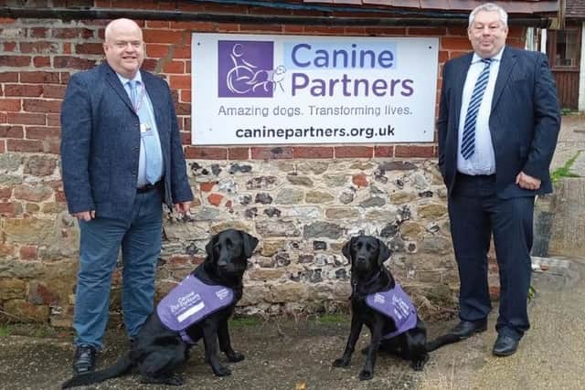 David Watson, corporate relationship manager at Canine Partners, left, with David Glover, joint chief executive at Worthing-based Caremark Limited