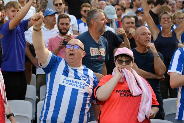 LONDON, ENGLAND - AUGUST 21: Fans of Brighton & Hove Albion celebrates their side's win after the final whistle of the Premier League match between West Ham United and Brighton & Hove Albion at London Stadium on August 21, 2022 in London, England. (Photo by Mike Hewitt/Getty Images)