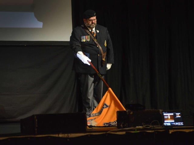 "Bridging Generations" Holocaust Memorial Day service at the White Rock Theatre in Hastings on January 24. The Royal Sussex Regiment - Lowering of the flag.