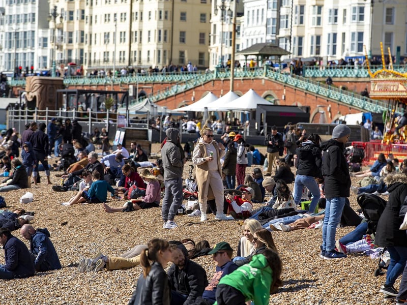 People enjoy the spring sunshine this Good Friday on Brighton beach in East Sussex.