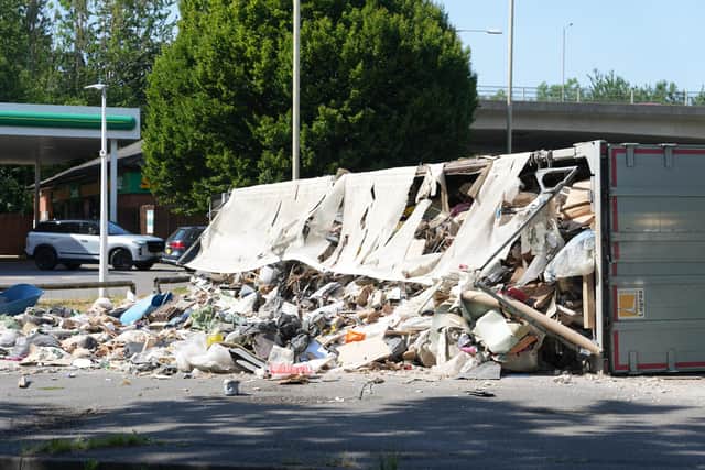 An articulated lorry came to rest on its side on the A23 London Road at the Mill Road roundabout, beside a BP petrol station. Photo: Eddie Mitchell