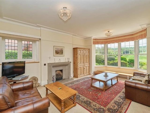 Impressive living and dining rooms, have bisecting wooden bi fold doors, and both have attractive bay windows with seating to take advantage of the infinity garden view.