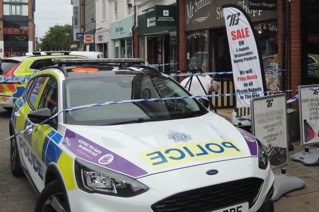 Part of Horsham town centre is cordoned off by police this morning following a large scale fight in which three people were seriously hurt. Thirteen people have been arrested