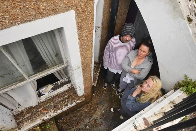 Property owner Sarah Lake, centre, with tenants David Lee and Flora Storm in June 2021 after the flat flooded