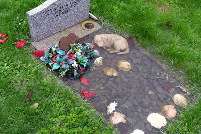The flooded grave of Ann Fiorentini's parents at Hills Cemetery in Horsham