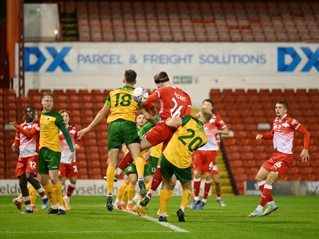 Jack Brivio of Horsham and Jamie McCart of Barnsley in action during the Emirates FA Cup First Round match between Barnsley and Horsham at Oakwell Stadium.
