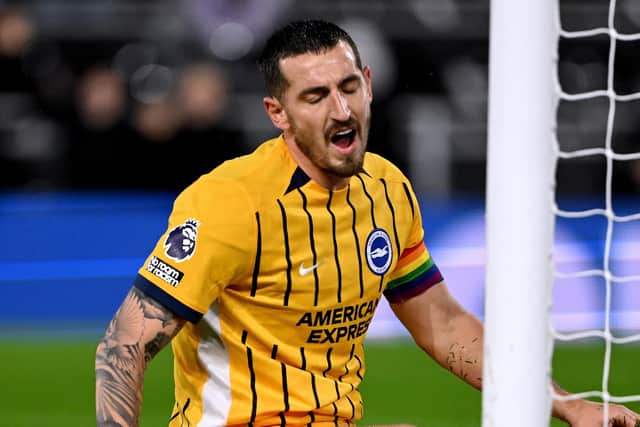Brighton skipper Lewis Dunk held up an odd sign on Night Five of the PDC Premier League darts competition about his boss Fabian Hurzeler. (Photo by Mike Hewitt/Getty Images)