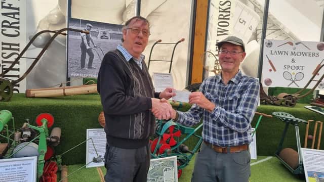 Derek Swaine (left) presents the cheque to Clive Gravett at the Museum of Gardening in Hassocks