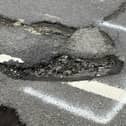One of the many deep potholes in St Leonard's Road, Horsham