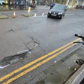 Pothole with cables hanging out of it on White Rock/junction of Robertson Street in Hastings.