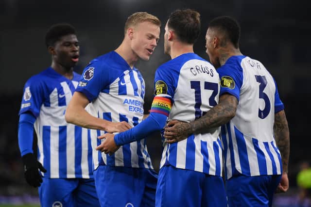 Jan Paul van Hecke congratulates goalscorer Pascal Gross during the Premier League match between Brighton & Hove Albion and Brentford FC | Photo by Mike Hewitt/Getty Images