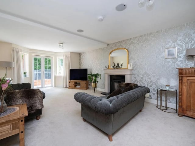 The living room has a stone fireplace with inset wood burning stove,