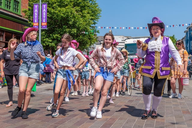 Town Crier Jane Smith joins square dances in the midst of the carnival. Photo: Neil Cooper