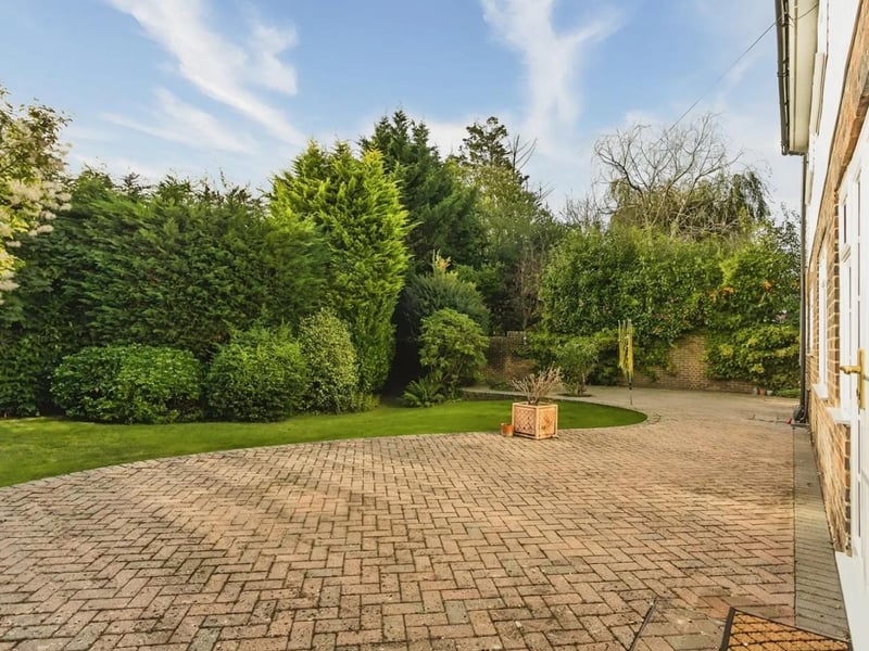 Outside, the house boasts attractive front and rear gardens
