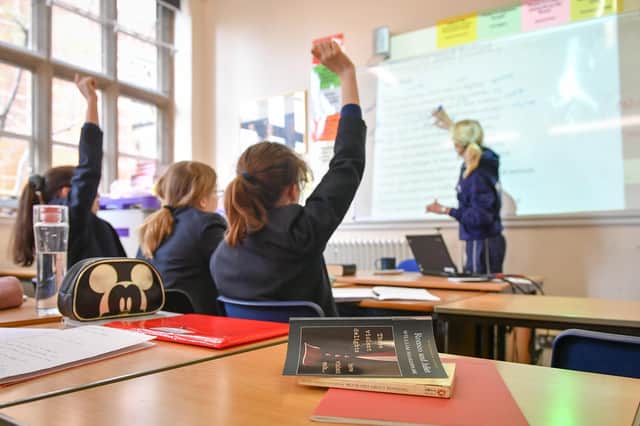 Students raise their hands as a teacher writes on a whiteboard to explain William Shakespeare's Romeo & Juliet during an English lesson at Royal High School Bath, which is a day and boarding school for girls aged 3-18 and also part of The Girls' Day School Trust, the leading network of independent girls' schools in the UK. 