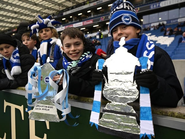 BRIGHTON, ENGLAND - JANUARY 29: Brighton & Hove Albion fans hold tin foil FA Cup trophies prior to the Emirates FA Cup Fourth Round match between Brighton & Hove Albion and Liverpool FC at Amex Stadium on January 29, 2023 in Brighton, England. (Photo by Mike Hewitt/Getty Images)