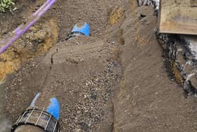 The newly installed blue pipe beneath the soil after the burst water main was repaired. Further work is needed to fix a leaking air valve. Photo: Southern Water